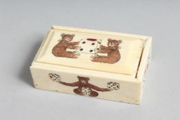 A BONE DICE BOX etched with teddy bears. 3.5ins long.
