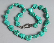 A TURQUOISE BEAD NECKLACE 18ins long.