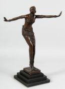 A BRONZE DECO DANCER on a stepped base. 17ins high.