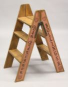 A PAIR OF NOVELTY ADVERTISING PINE STEPS. 2ft 8ins high.