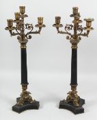 A GOOD PAIR OF FOUR LIGHT CANDLESTICKS on eagle bases. 23ins high.