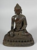 A BRONZE GOD seated crossed leg. 9ins high.