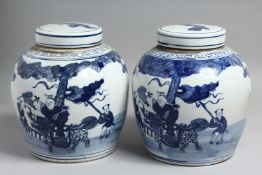 A GOOD PAIR OF CHINESE BLUE AND WHITE GINGER JARS AND COVERS. 10ins high.