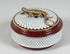 A PORCELAIN CIRCULAR BOX AND COVER with lizard handle. 5ins diameter.