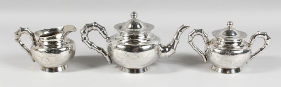 A CHINESE SILVER TEA SET engraved with birds with bamboo pattern handles and spout, comprising
