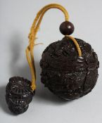 A JAPANESE CARVED WOOD BALL INRO on a rope. 2ins