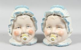 A PAIR OF BABY'S HEADS BOXES. 5ins high.