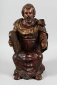 A 17TH CENTURY, POSSIBLY ITALIAN CARVED POLYCHROME FIGURE OF MOSES holding a tablet. 18ins high.