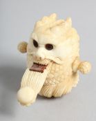 A HAND CARVED BONE DRAGON TAPE MEASURE. 2.5ins