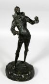 A 19TH CENTURY FRENCH BRONZE OF A JESTER on a rocky base. 12ins high.