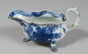 AN EARLY BOW SAUCEBOAT on three paw feet painted in underglaze blue with chrysanthemum and peony and