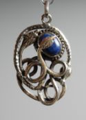 A SILVER AND LAPIS SNAKE PENDANT.