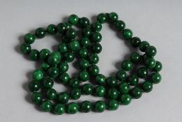 A LONG STRING OF MALACHITE BEADS. 30ins long.