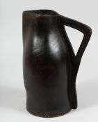 A GOOD EARLY LEATHER BOMBARD. 12ins high.