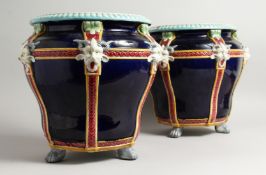 A GOOD PAIR OF MINTON BLUE AND WHITE POTTERY JARDINIERE with mask mounts on claw feet. 12ins high,