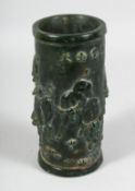 A CHINESE CARVED JADE BRUSH POT carved with BULLS. 8ins high.