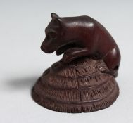 A JAPANESE CARVED WOOD NETSUKE BOAR. 1.75ins.