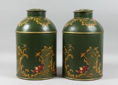 A PAIR OF GREEN TOLEWARE TEA CANISTERS AND COVERS. 14ins high.
