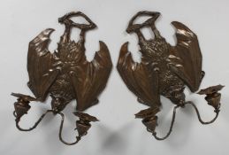 A PAIR OF METAL BAT WING SCONCES. 12ins.