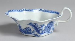 AN EARLY BOW SAUCE BOAT with flat unglazed base and unusual handle painted in underglaze blue,
