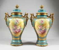 A PAIR OF GERMAN BONN TWO HANDLED VASES with blue and gilt ground painted with reverse panels of