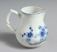 A VERY EARLY BOW CREAM JUG painted in bright blue with flowers and a fence.