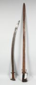 TWO EARLY MOROCCAN NIMCHA SWORDS, each with wooden handles, 106.5cm and 83cm long, (2).