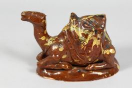 A TURKISH CANAKKALE GLAZED POTTERY FIGURE OF A CAMEL, 16cm long.