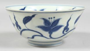 A CHINESE BLUE AND WHITE PORCELAIN BOWL, the interior and exterior painted with flora, the base with