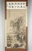 A CHINESE SCROLL PAINTING ON SILK depicting a mountainous landscape with buildings and trees, with
