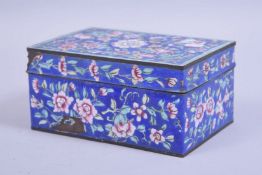 A 19TH CENTURY CHINESE CANTON ENAMEL LIDDED BOX, with a blue ground and floral decoration, 15cm