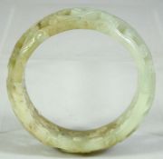 A CHINESE CARVED AND PIERCED JADE BRACELET, 8cm diameter.
