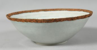 A CHINSE CELADON GLAZE BOWL, the interior carved with foliate decoration. 18cm diameter