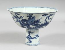 A CHINESE BLUE AND WHITE PORCELAIN PETAL-FORM STEM CUP, the exterior decorated with dragons and