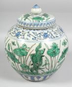 A LARGE CHINESE FAMILLE VERTE PORCELAIN JAR AND COVER, the body with band of fish and aquatic flora,