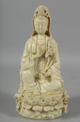 A GOOD BLANC DE CHINE FIGURE OF A SEATED GUANYIN ON LOTUS BASE, the reverse bearing two marks.