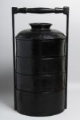 A CHINESE BLACK LACQUERED FOOD CARRIER, containing three detachable trays and lid, overall 44cm