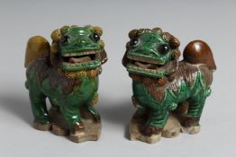 A PAIR OF CHINESE GREEN GLAZED POTTERY LION DOGS. 10cm high