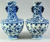 AN UNUSUAL PAIR OF CHINESE BLUE AND WHITE PORCELAIN VASES, the neck and shoulders decorated with