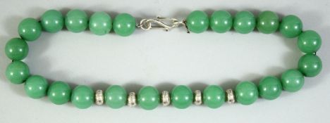A SET OF CHINESE GREEN HARDSTONE BEADS, comprising 24 beads, with 5 white metal roundels, each