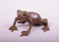 A SMALL JAPANESE BRONZE MODEL OF A FROG, stamped underside, 4cm long.