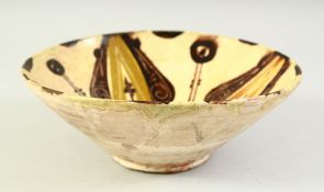 AN AFGHAN PART-GLAZED POTTERY BOWL, the interior decorated with stylised motifs. 20cm diameter