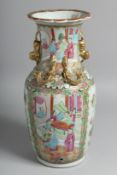A CHINESE CANTON PORCELAIN VASE painted with panels of figures, along with birds and native flora,