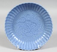 A CHINESE POWDER-BLUE RIBBED PORCELAIN BOWL, the central interior carved with dragon and stylised