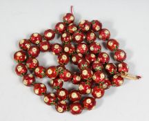 A FINE INDIAN STRAND OF ENAMELLED JEWELLED YELLOW METAL BEADS, comprising 53 beads.