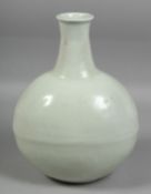 A CHINESE WHITE GLAZED PORCELAIN MOON FLASK, with incised floral decoration, with four-character