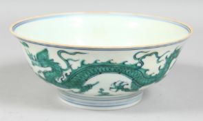 A CHINESE PORCELAIN FAMILLE VERTE DRAGON BOWL, six-character mark to base. 18cm diameter