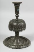 AN 18TH/19TH CENTURY PERSIAN QAJAR CANDLESTICK, 19cm high.