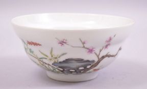 A GOOD CHINESE FAMILLE ROSE PORCELAIN TEA BOWL, decorated with a bird and native flora, with six