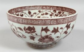 A CHINESE UNDERGLAZE RED PORCELAIN BOWL, foliate decoration, and Greek key rim. 19.5cm diameter